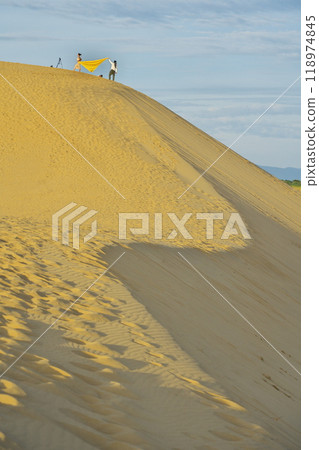 Summer in Tottori Prefecture, Tottori Sand Dunes, Tourists taking photos on horseback in the early morning 118974845