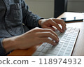 Hands typing on a white keyboard. Hands typing or programming at a wooden desk. 118974932