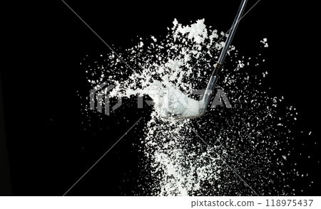 Golf Ball golfer hit snow to explode and splatter. Sand wedge golf dick ball from snow field and snow fly in air. Night black background isolated 118975437