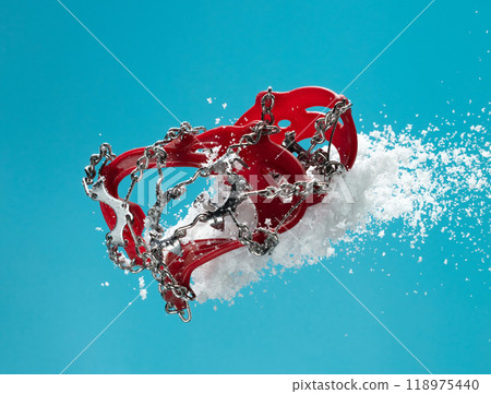 Hiking trail in winter should wear Crampons snow spike on shoes to protect slippery on ice icy surface road. Crampon spike shoe walk good on snow, blue sky background isolated 118975440