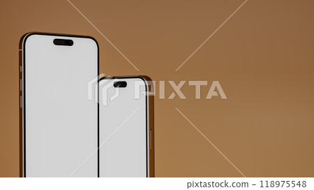 Two smartphones blank screen close up with warm gradient background, 3d render Two smartphones blank screen close up with warm gradient background, 3d render 118975548