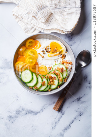 Savory cottage cheese bowl with egg, tomatoes and cucumber. 118975587