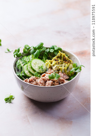 Asian salad bowl with tuna, avocado and cucumber. Asian salad bowl with tuna, avocado and cucumber. 118975591