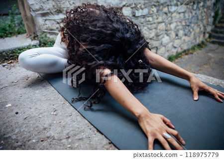 brunette woman doing yoga asana outdoor gymnastics 118975779
