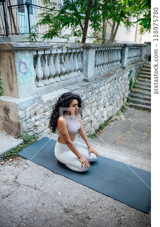 brunette woman doing yoga asana outdoor gymnastics brunette woman doing yoga asana outdoor gymnastics 118975780
