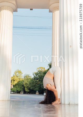 athletic woman doing gymnastics yoga asana outdoors athletic woman doing gymnastics yoga asana outdoors 118975789