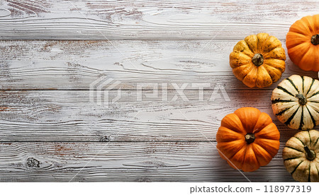 Pumpkin and Gourd Cluster on Whitewashed Wooden Table for Rustic Fall Decor 118977319