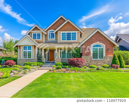 A beautiful home with a large front yard and blue sky in the background, representing the high-end residential real estate market of North America.  118977920