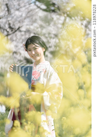 Female university student at graduation ceremony Female university student at graduation ceremony 118978228