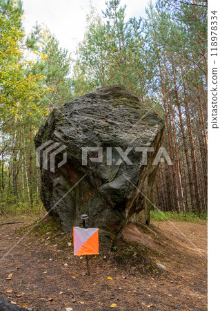 Control point Prism and electric composter for orienteering near the boulder in the fall forest Control point Prism and electric composter for orienteering near the boulder in the fall forest 118978334