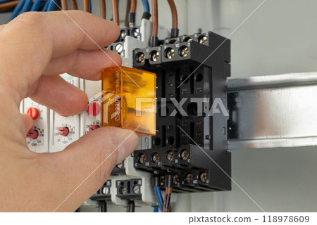 Inserting relay into electrical control panel 118978609