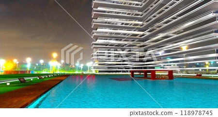 Waterfront with benches and lawn lights along a large azure pool on the grounds of an elite home against the backdrop of a nighttime village. 3D rendering. 118978745