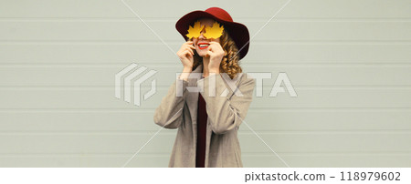 Autumn portrait beautiful happy smiling woman with yellow maple leaves, stylish joyful girl in hat Autumn portrait beautiful happy smiling woman with yellow maple leaves, stylish joyful girl in hat 118979602