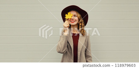 Autumn portrait beautiful happy smiling woman with yellow maple leaves, stylish joyful girl in hat Autumn portrait beautiful happy smiling woman with yellow maple leaves, stylish joyful girl in hat 118979603