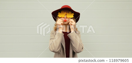 Autumn portrait beautiful happy young woman with yellow maple leaves, stylish joyful girl in hat Autumn portrait beautiful happy young woman with yellow maple leaves, stylish joyful girl in hat 118979605