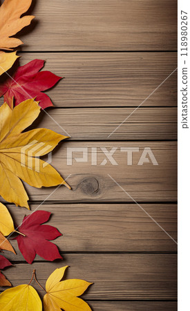 Wooden table with colorful autumn leaves on it creating a frame around the background copy space for advertising text. Top view 118980267