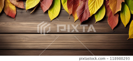 Wooden table with colorful autumn leaves on it creating a frame around the background copy space for advertising text. Top view Wooden table with colorful autumn leaves on it creating a frame around the background copy space for advertising text. Top view 118980293