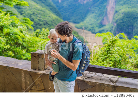 Dad and his baby son travelers exploring Sumidero Canyon National Park, Mexico. Adventure, natural exploration, and travel experience concept Dad and his baby son travelers exploring Sumidero Canyon National Park, Mexico. Adventure, natural exploration, and travel experience concept 118980402