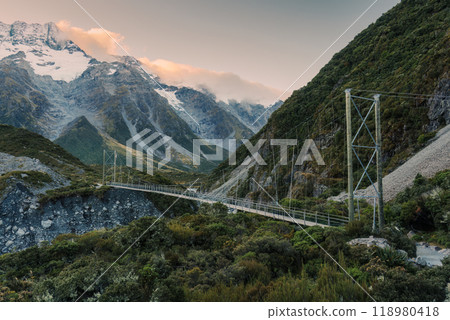 View of suspension bridge with mountain range on Hooker Valley Track in national park at New Zealand View of suspension bridge with mountain range on Hooker Valley Track in national park at New Zealand 118980418