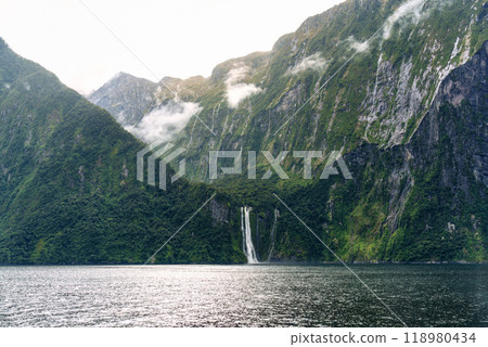 Majestic mountain with cascade flowing and foggy in Milford Sound at Fiordland national park, New Zealand 118980434