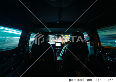 Inside car driving through the street of night city 118980467