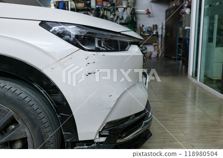 Front of white SUV car suffered damage and broken to bumper and body 118980504