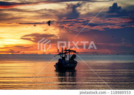 Colorful sunrise sky over fishing boat in tropical sea Colorful sunrise sky over fishing boat in tropical sea 118980553