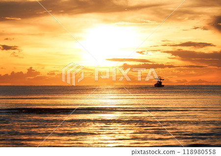 Golden sunrise over tropical sea with fishing boat 118980558