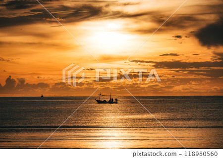 Golden sunrise over tropical sea with fishing boat 118980560