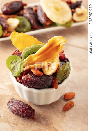 Dried tropical fruits with various nuts and raisins. Dried tropical fruits with various nuts and raisins. 118981039