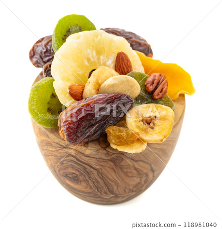 Dried tropical fruits, nuts, and raisins isolated on white. Dried tropical fruits, nuts, and raisins isolated on white. 118981040