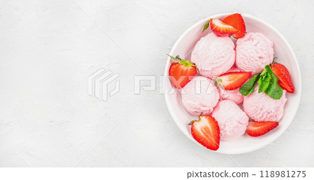 pink strawberry ice cream ball in a spoon in white bowl pink strawberry ice cream ball in a spoon in white bowl 118981275