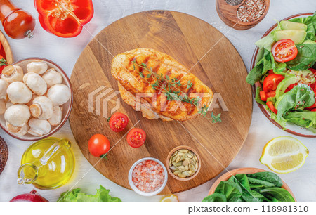 grilled chicken fillet on wooden cutting board. banner, menu, recipe copy space, top view 118981310