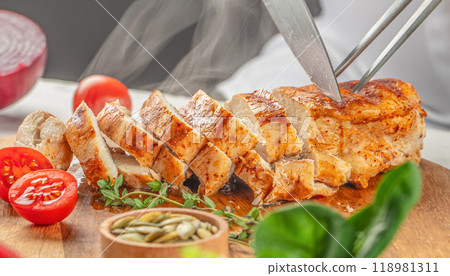 Grilled chicken breast sliced on wooden table. Food recipe background. Close up 118981311
