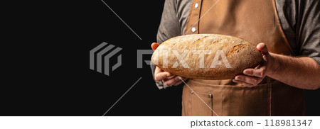 Baker man holding whole grain bread. Homemade sourdough bread. Vegan or gluten free diet 118981347