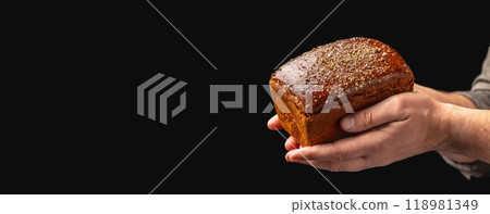 Man holding fresh baked bread. rye wheat loaf of bread. gluten-free bread Man holding fresh baked bread. rye wheat loaf of bread. gluten-free bread 118981349
