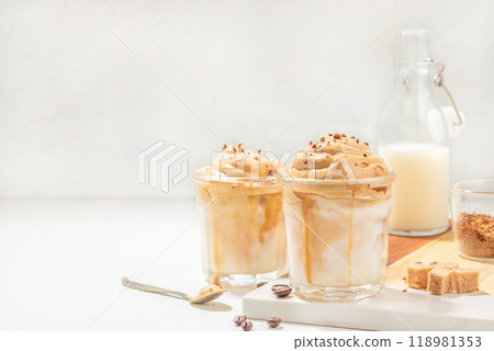 Dalgona whipped, instant, cream coffee on a light background. trendy and popular drink 118981353
