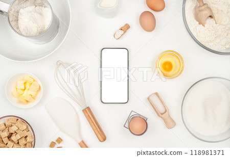 mobile phone gadget smartphone with Baking pastry or cake ingredients on a white background top view. copy space 118981371