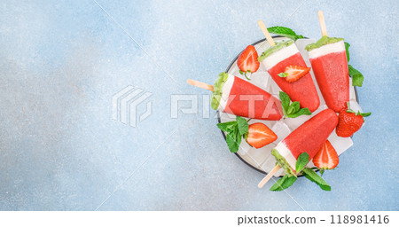 Homemade strawberry and kiwi popsicles, sweet and natural ice cream dessert. Summer food concept Homemade strawberry and kiwi popsicles, sweet and natural ice cream dessert. Summer food concept 118981416