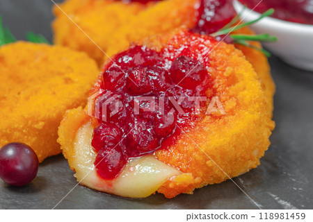 Baked Camembert breaded with cranberry sauce, Food recipe background. Close up Baked Camembert breaded with cranberry sauce, Food recipe background. Close up 118981459