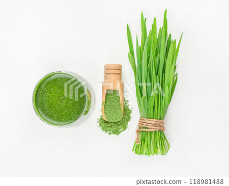 Fresh wheat grass and powder on white background, Healthy drink with organic green smoothie, Detox superfood. Fresh wheat grass and powder on white background, Healthy drink with organic green smoothie, Detox superfood. 118981488