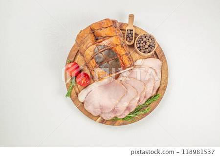 Sliced smoked ham with herbs and aromatic spices on plate 118981537