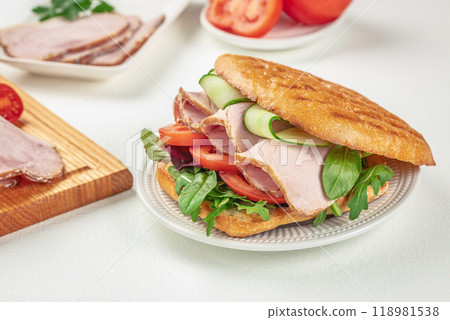 sandwich with pork ham, cheese and salad on a light background, top view. copy space 118981538