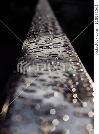 Detail of Water droplets caused by rain perched on the metallic surface. 118981561