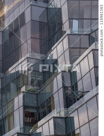 Architecture exterior of Modern building with many glass wall reflecting with the sky background at afternoon. 118981565