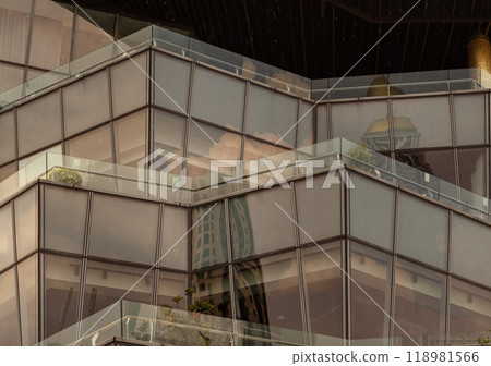Architecture exterior of Modern building with many glass wall reflecting with the sky background at afternoon. 118981566