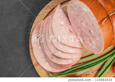 Tasty meat sausages. Turkey Boiled Ham on a wooden board, top view. copy space 118981616