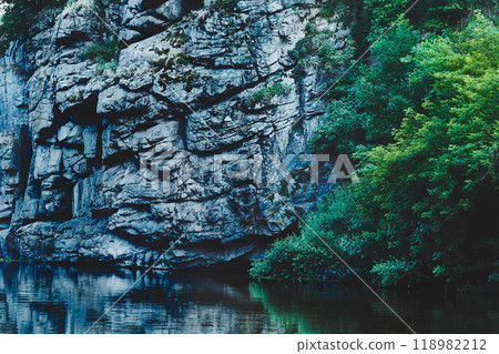 Deep silver canyon with smoothly flowing water Deep silver canyon with smoothly flowing water 118982212