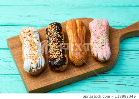Assorted eclairs on a pastel top view Traditional French dessert Assorted eclairs on a pastel top view Traditional French dessert 118982349
