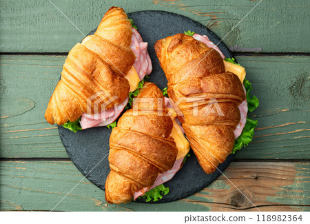 Croissant sandwich with salad ham and cheese . Top view 118982364